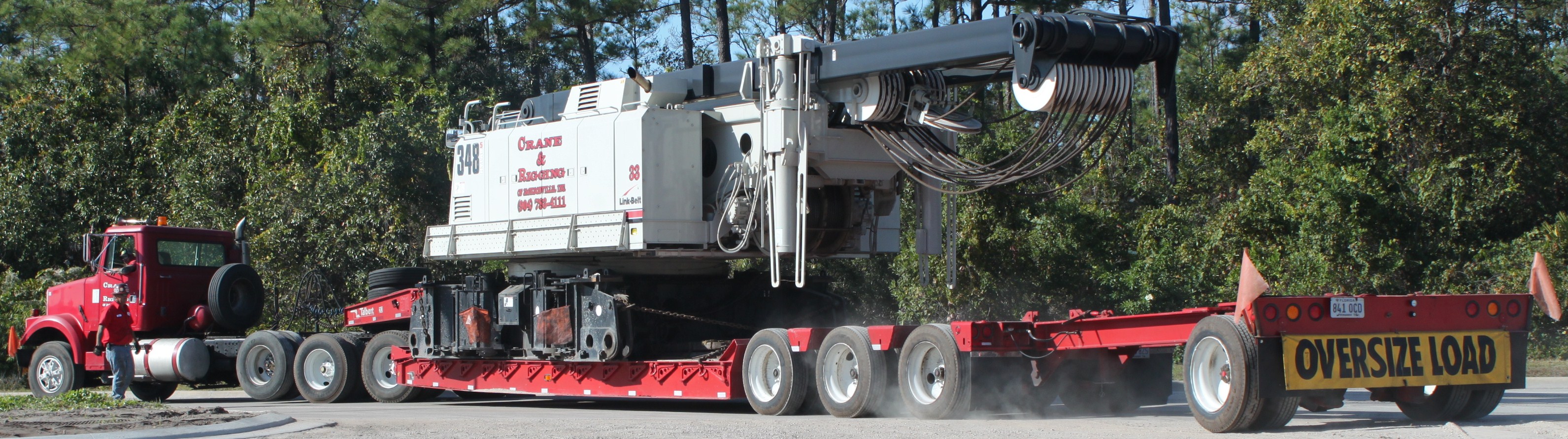 Lowboy trailer transporting a crawler crane.