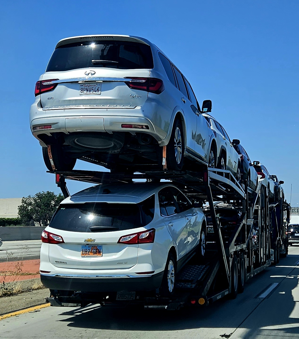 Multi-level automobile transporter carrying passenger vehicles.